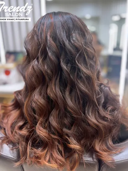 This mocha brown hair color is rich and dimensional. The soft waves and subtle highlights create a look that is both trendy and timeless.