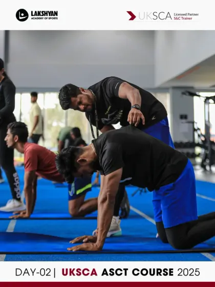 Peer coaching in action. On Day 2, participants practice instructing each other on foundational movements like the cat-camel stretch, building their confidence and communication skills.