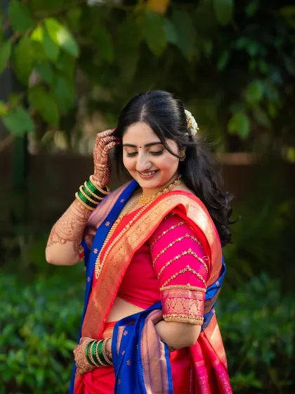A lovely solo portrait of the bride, Jagruti, showcasing her stunning saree, hairstyle, and joyful expression.