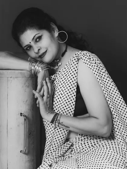 A beautiful black and white portrait in a polka dot saree, capturing a moment of quiet confidence.