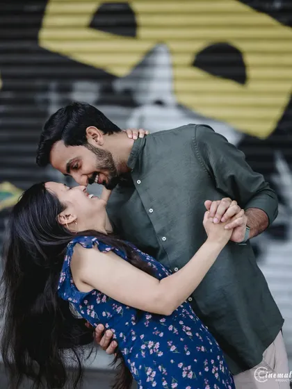 A fun, dynamic dip pose against a graffiti wall. This captures the couple's playful energy and creates a memorable, action-filled shot that stands out.
