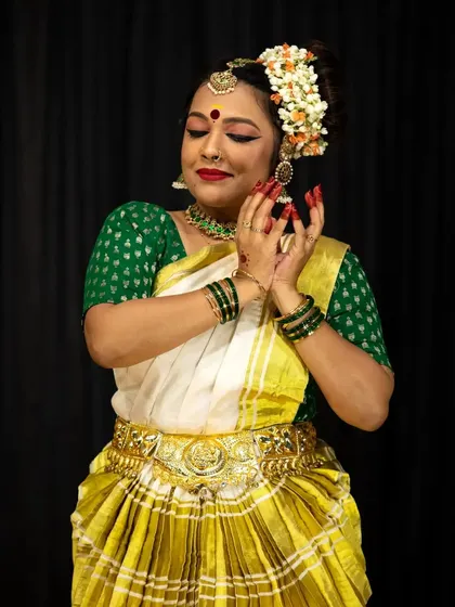 A moment of quiet grace from a student's solo debut, highlighting the beautiful traditional costume and jewelry.