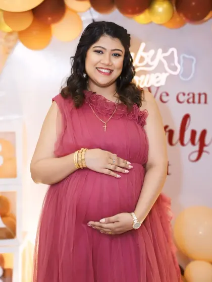 A full-length view of our wine-colored ruffled gown, showing how its gentle layers create a flattering A-line silhouette perfect for a baby shower.
