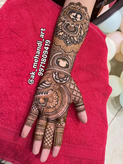 The complete baby shower mehndi, extending from the forearm to the fingertips with beautiful, consistent patterns.