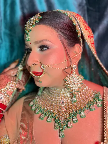 Adjusting the final details. This shot captures the rich colors of her outfit and the way the makeup enhances her features.