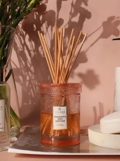 A close-up of our Peach Bellini reed diffuser in a bathroom setting. The textured pink glass jar is a beautiful decor piece that provides continuous, effortless fragrance.