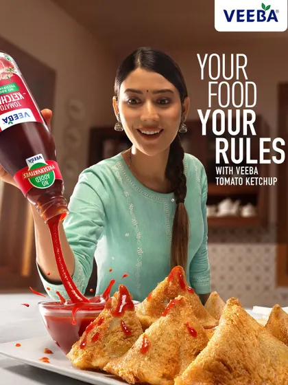 The final ad layout for the Veeba ketchup campaign, combining the action shot with the brand's tagline. This version shows how the photography works within a complete advertisement to communicate a clear, powerful message.