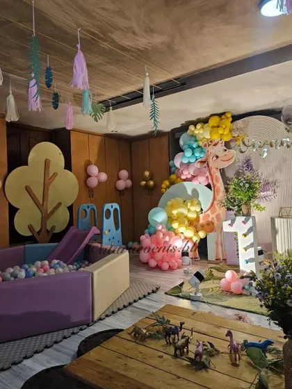 Another view of the pastel jungle party, showing the ball pit, main stage with animal props, and themed low seating for a complete and cohesive look.
