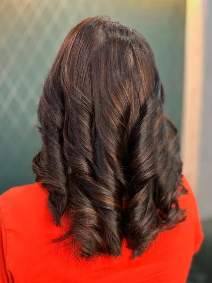 A different angle of the natural brown curls, showing the depth and timeless appeal of this color.