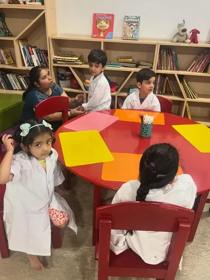 Our little scientists, dressed in their lab coats, listen intently during a science camp session. The right environment makes learning feel like an adventure.