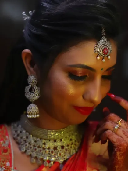 Another artistic shot of the same reception look, highlighting the bold red lip and the intricate details of her diamond jhumkas.