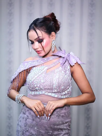 This shot highlights the delicate beadwork on the bodice of the lilac gown.