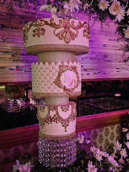 A close-up of the intricate gold baroque details and quilted pattern on the chandelier cake.