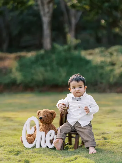 A classic first birthday portrait. This little boy looks so handsome and ready to celebrate his big day with his teddy bear by his side.
