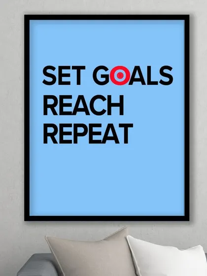 Our "Set Goals, Reach, Repeat" print, shown in a living room setting. The bold colors and message make it a standout piece of modern, inspirational art.