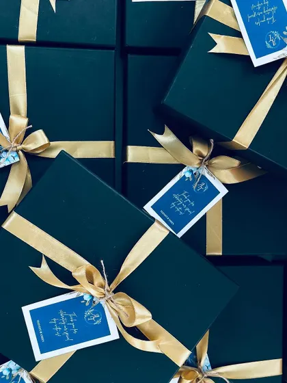 A stack of our sophisticated black and gold favor boxes, waiting to be delivered for a special wedding.