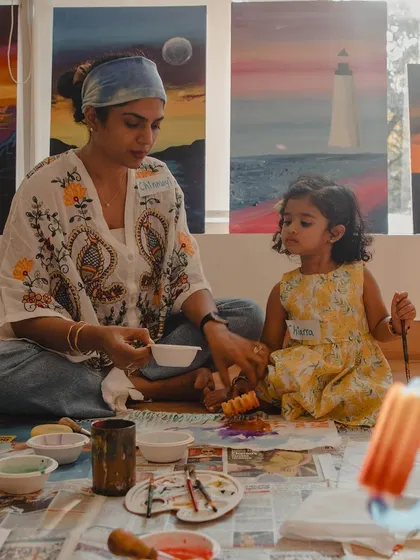 A mother and daughter work together on a craft project during our Holi playdate. These moments of focused creativity are a wonderful way for families to bond.