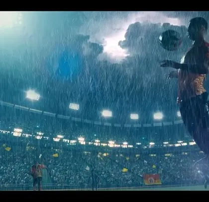 A heroic shot of a player from the East Bengal FC film, capturing a moment of skill and control in the pouring rain.