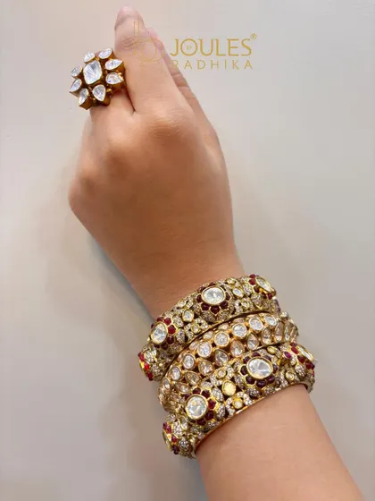 A beautiful stack of ruby and polki kadas, paired with a matching floral polki ring. This shows how to create a cohesive look for your hands.