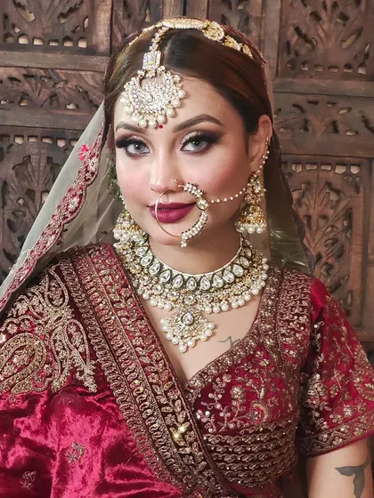 This image showcases a full bridal set with a heavy Kundan choker, matching earrings, a large maang tikka, and a classic nath. We can adjust the size and details of each piece.