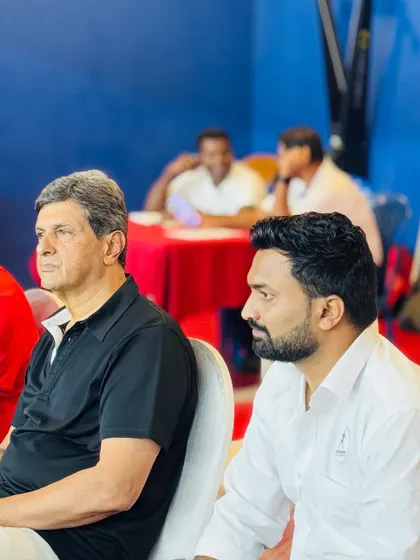 Prakash Padukone intently watching a match courtside. His presence as a mentor provides immense motivation to all players competing in the tournament.