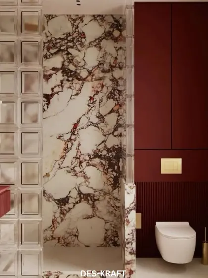 The bathroom's layout showcases the seamless integration of the toilet and storage, with the bold red and marble creating a cohesive and powerful statement.