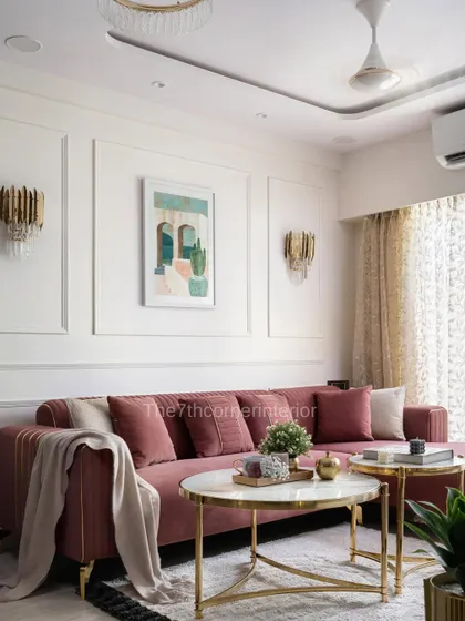 In 'The Adobe' project, I used a muted pink L-shaped sofa to add a playful yet sophisticated element. The design is complemented by classic wall paneling and modern gold wall sconces.