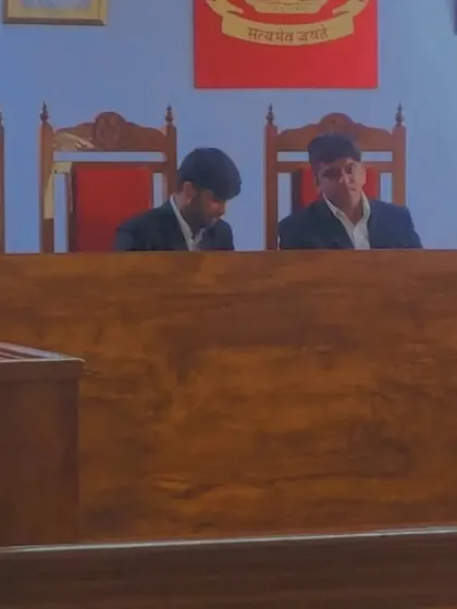 Judging a moot court session within the impressive courtroom setup at Manipal University.