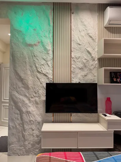 I created this stone texture to run across the TV unit and onto the adjacent pillar in a master bedroom. This technique creates a cohesive, aesthetic look that unifies the space.