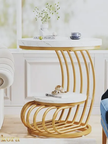 This unique metal coffee table features a flowing, C-shaped frame made of multiple gold-finish tubes. The design provides two useful surfaces while acting as a striking piece of sculptural furniture.