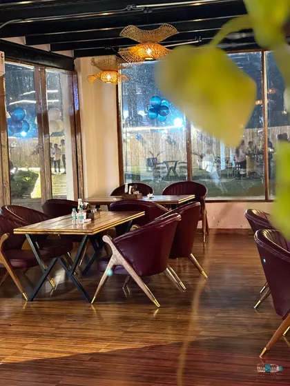 A table with a view. Our indoor seating overlooks the pool and lawns, so you never feel disconnected from the outdoors.