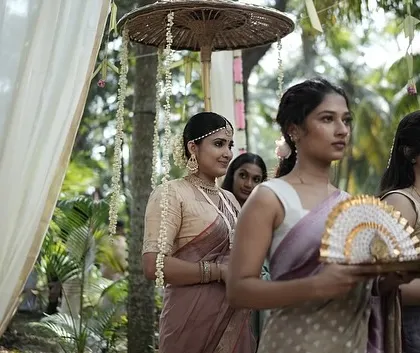 A closer look at the bride during her entrance. Her makeup features a classic winged eyeliner and a traditional bindi, key elements that define the South Indian bridal aesthetic I specialize in.