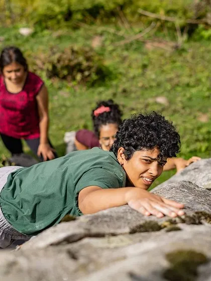 A duplicate of 81, celebrating the joy of reaching the top. It's a shared victory for the climber and her spotters.