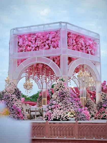 The mandap viewed from the side, highlighting the layers of flowers and the elegant arched design. Every angle was designed to be picture-perfect.