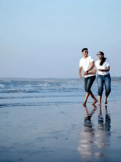 Running along the wet sand, their reflections mirroring their joy. I love capturing the energy and freedom that a beach location inspires in couples.