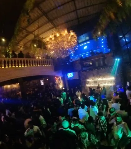 A fisheye lens captures the grand scale and packed floor of the club.