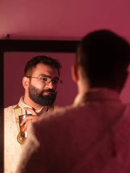 The groom's reflection, a moment before 'I do.' This portrait captures the quiet confidence and anticipation of a man about to begin his new chapter.