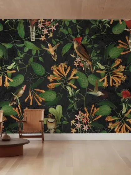 This dark, botanical wallpaper is filled with intricate illustrations of birds and flowers. The rich, detailed pattern creates a sophisticated and cozy atmosphere, reminiscent of a classic naturalist's study.