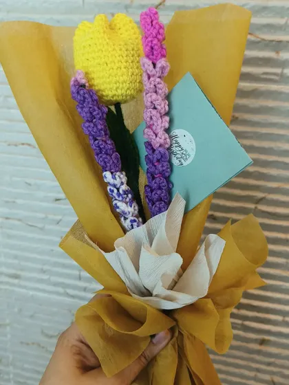 A lovely custom bouquet featuring a yellow tulip and lavender stems, complete with a "Happy Birthday" tag.