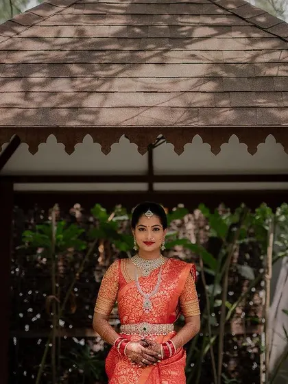 The bride's grand entrance under a beautiful floral canopy. This shot captures the tradition and elegance of a Telugu wedding ceremony.