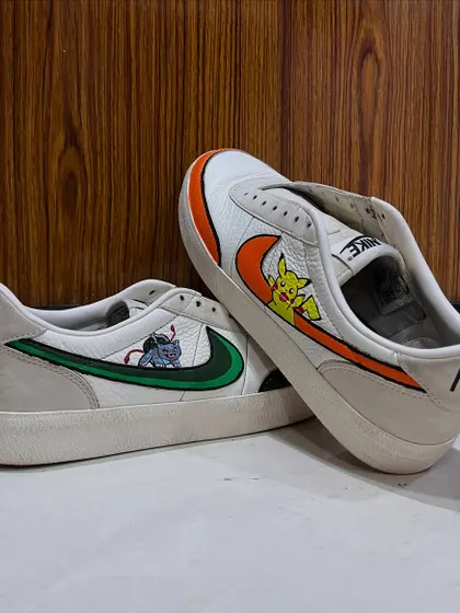 Another perspective of the finished Pokémon sneakers, showing how the art wraps around the shoe. This custom shoe painting project is a great example of how to personalize your favorite footwear.