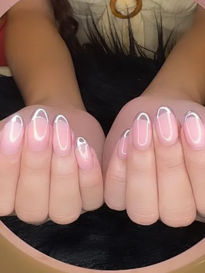 A full view of the lavender chrome outlined French manicure, a unique and eye-catching style.