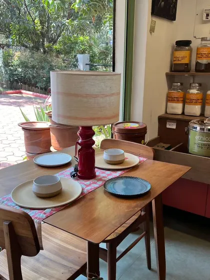 This image from our partner Ethico features our red 'Bloom' lamp, a design inspired by my love for nature. The stacked, glossy base is a hallmark of the Channapatna craft, paired here with a simple fabric shade.