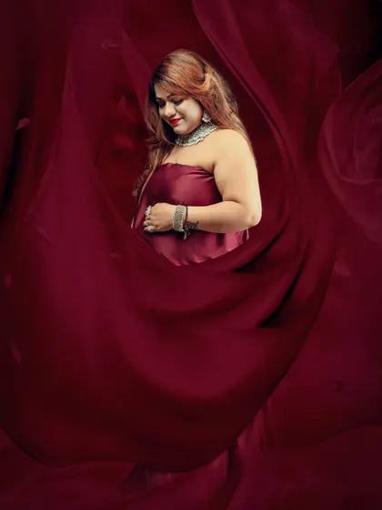 Dramatic and artistic portraits using a deep maroon fabric. I use creative lighting and reflection effects to craft these unique, fine-art maternity images.