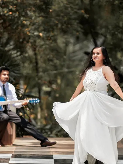 Another shot from the chess-themed session, this time creating a story with the groom playing guitar for his dancing bride-to-be.