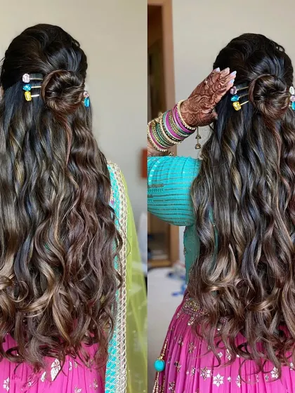 I love this messy-chic half-up bun paired with long, textured waves. It's a playful and stylish look, made possible with extensions for that extra length and volume.