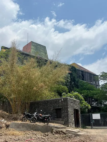 A wider view of the Avasara campus shows how the buildings are nestled within the landscape. Over time, the trees and climbing plants have grown to become the dominant feature of the site.