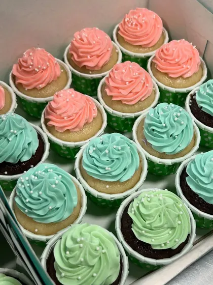 Adorable pink and teal cupcakes for a baby shower. These simple swirls with a sprinkle of white nonpareils are perfect for celebrating a new arrival.