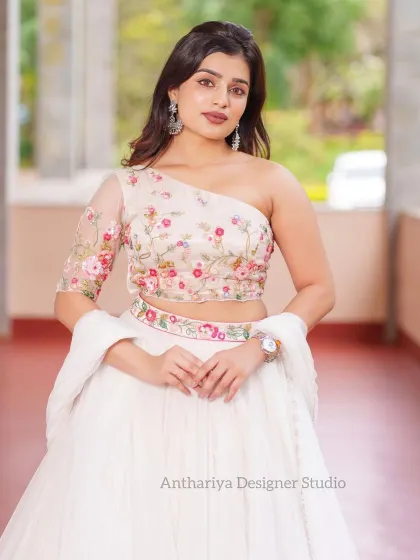 An identical medium shot, offering a clear view of the blouse and waist details.