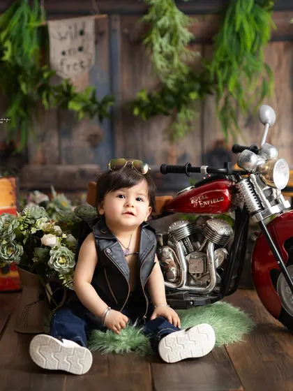 A cool and casual pose from our little biker. This shot captures a quiet moment amidst the fun and energy of the themed session.
